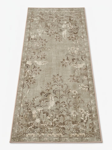 Machine washable botanical area rug in warm natural tones